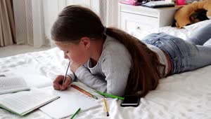 Stock Video Girl Doing Her Homework On Her Bed Live Wallpaper For PC