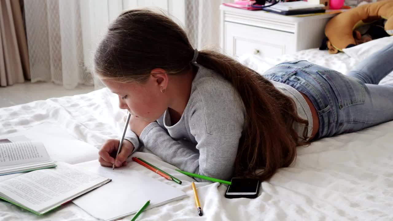 Download Stock Video Girl Doing Her Homework On Her Bed Live Wallpaper For PC