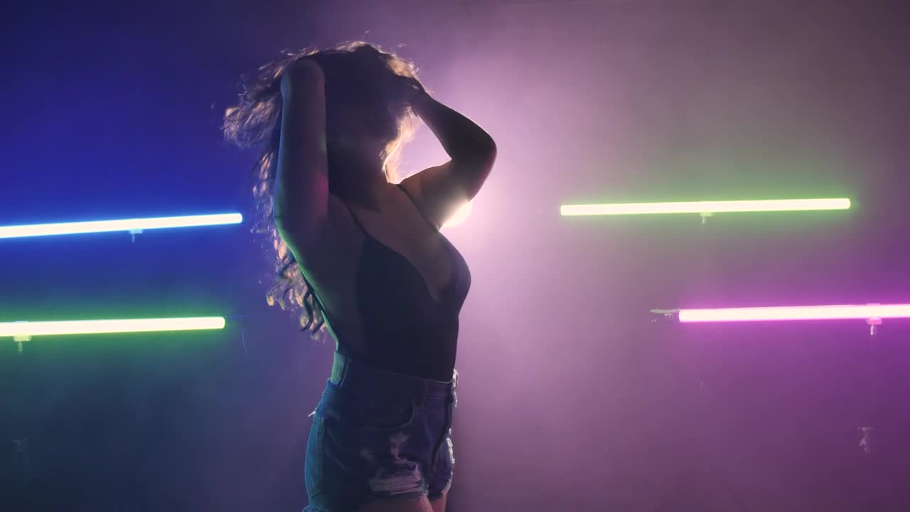 Download Stock Video Girl Dancing On A Dark Floor Under Colored Lights Live Wallpaper For PC
