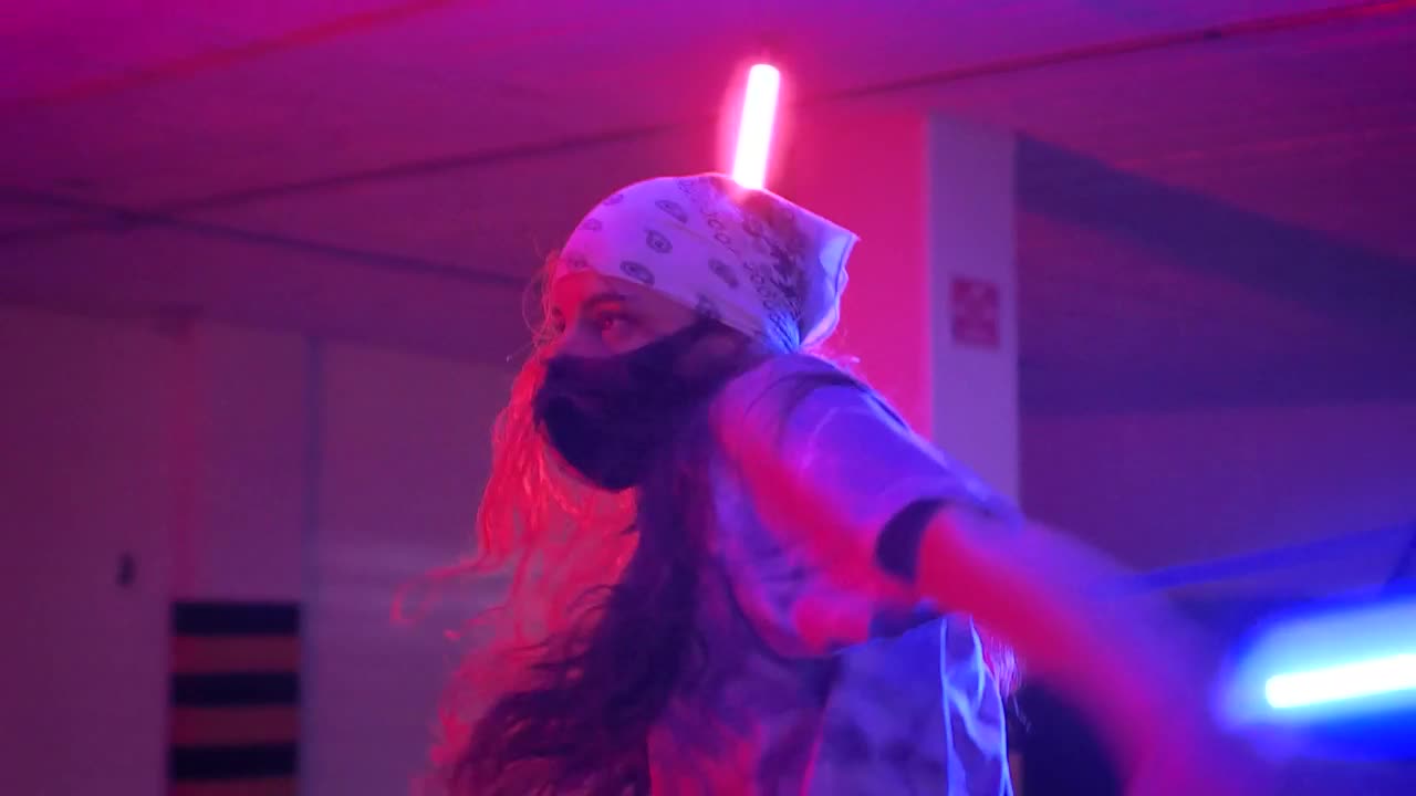 Download Stock Video Girl And Boy With Masks Dancing Under Colored Lights Live Wallpaper For PC