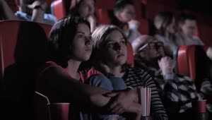 Stock Video Friends Watching A Horror Film In The Cinema Live Wallpaper For PC