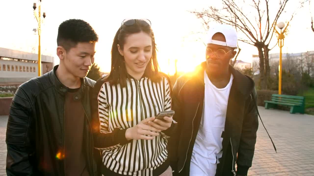 Download Stock Video Friends Walking Down The Street Watching Social Media Live Wallpaper For PC