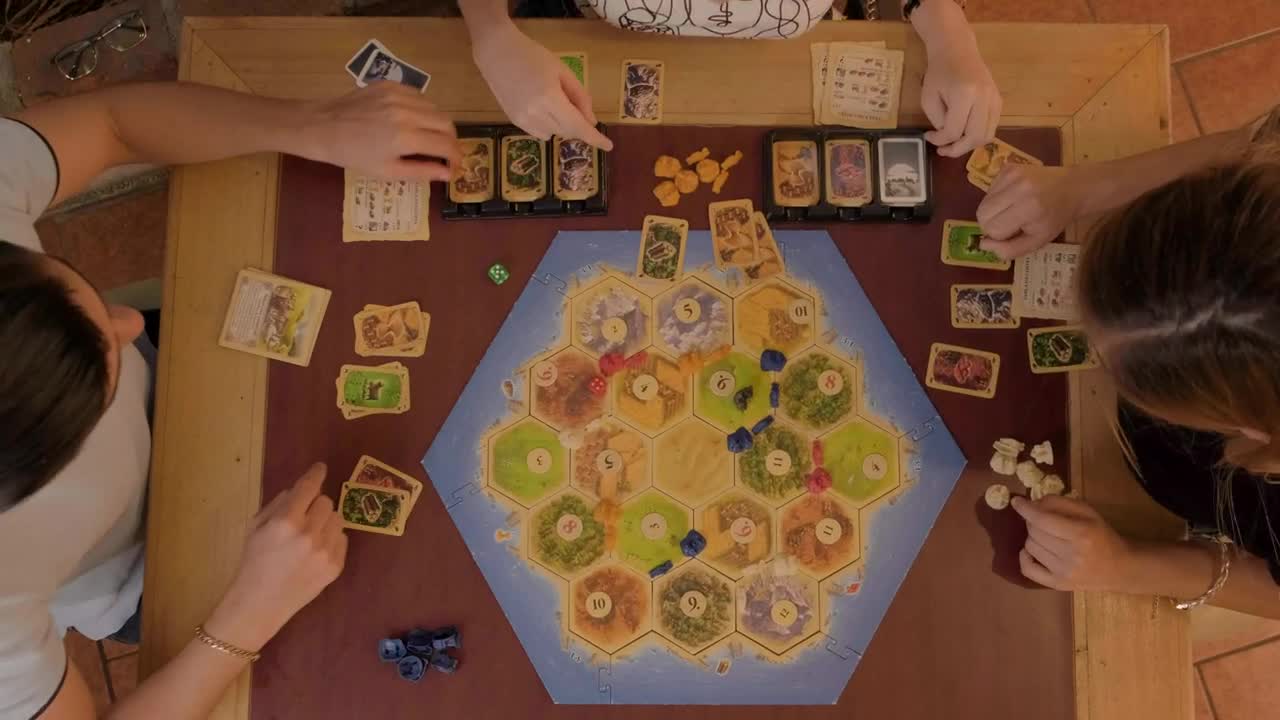 Download Stock Video Friends Playing Catan Sitting At A Table Live Wallpaper For PC