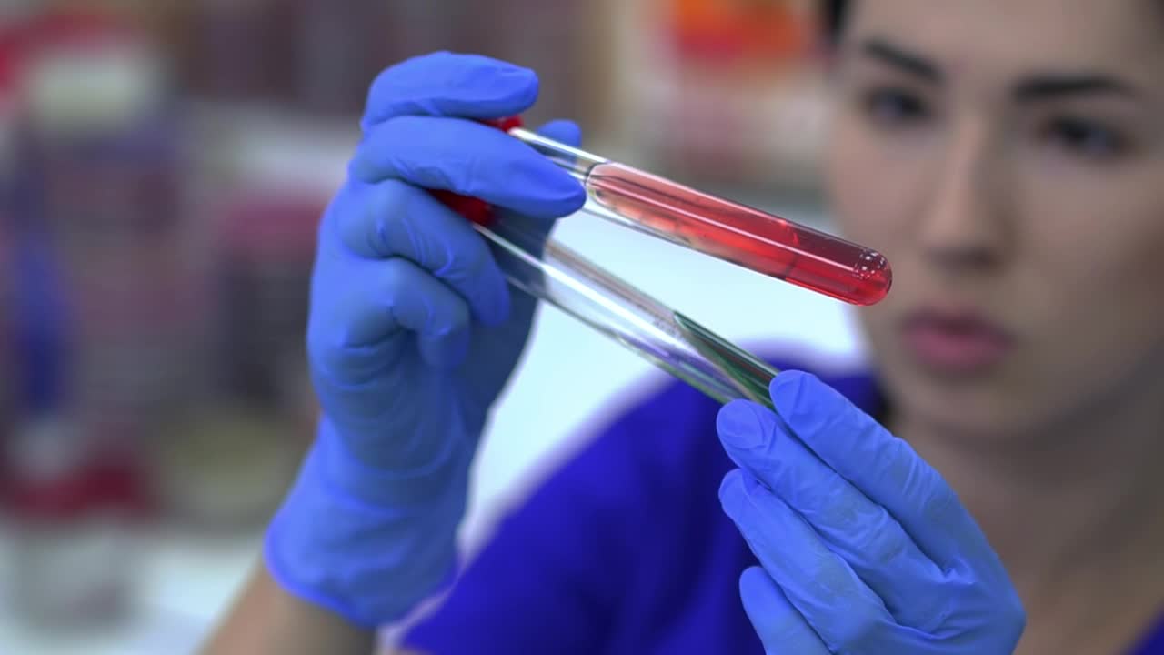 Download Stock Video Laboratory Worker Looking At A Test Tube Animated Wallpaper