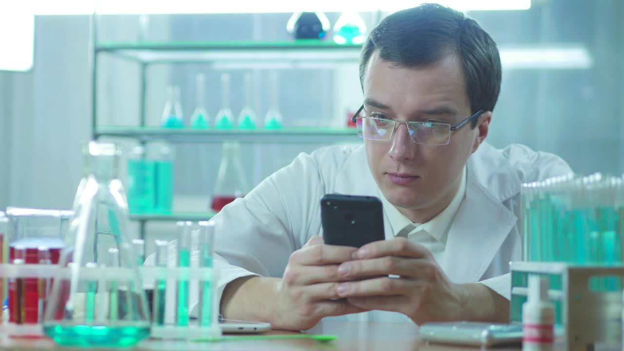 Download Stock Video Laboratory Scientist Looking At The Phone Animated Wallpaper