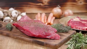 Stock Video Keto Diet Seasoned Raw Steak On Wood Board Animated Wallpaper