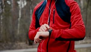 Stock Video Jogger Checks Heart Rate On Smartwatch In Forest Animated Wallpaper