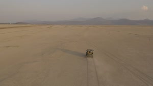 Stock Video Jeep Truck Traveling Through A Desert Seen From The Air Animated Wallpaper
