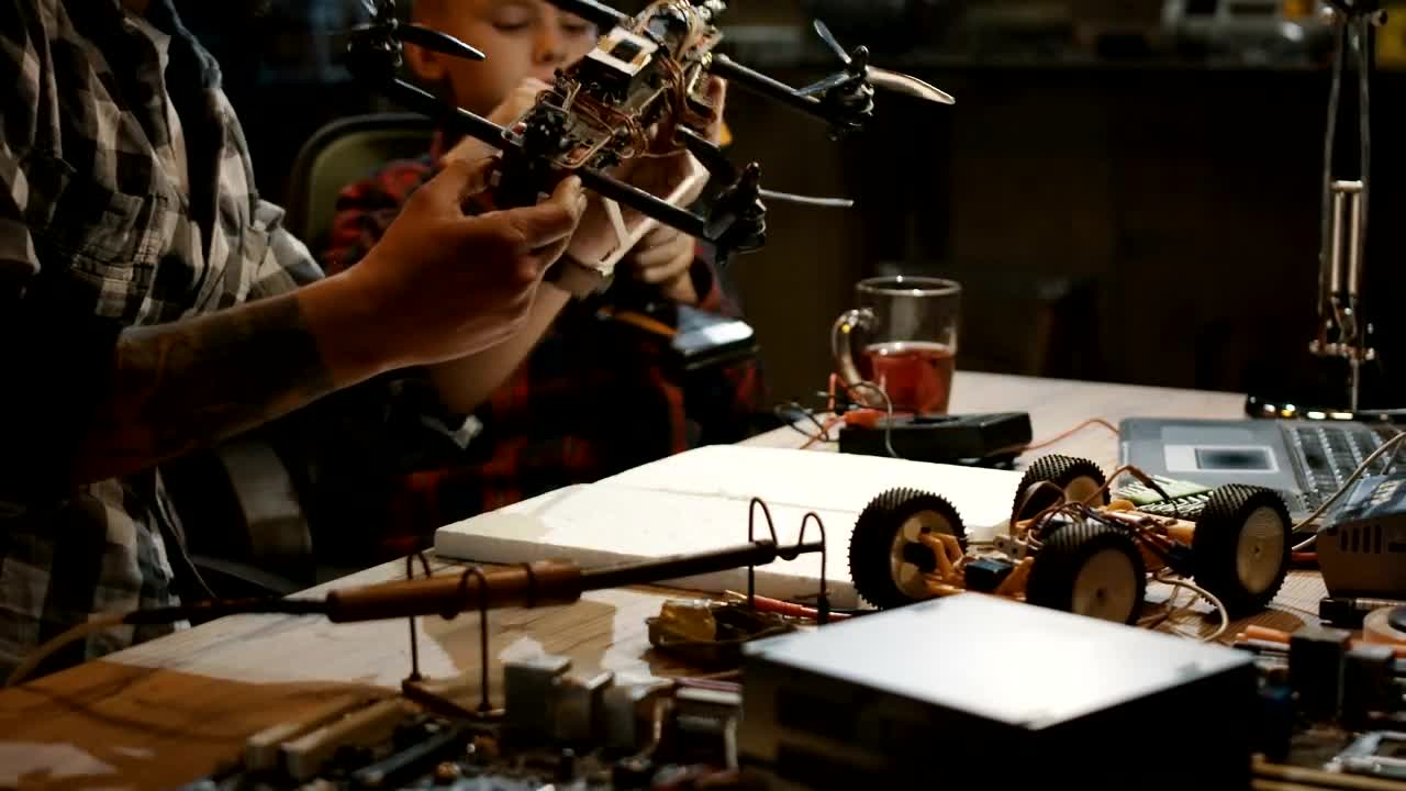 Download Stock Video Inspecting A Drone In A Workshop Animated Wallpaper
