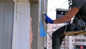Stock Video Industrial Climbers Applying Cement To A Building Animated Wallpaper