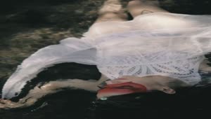 Stock Video Indie Fashion Girl Laying Down On Water Animated Wallpaper