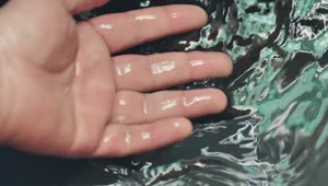 Stock Video Immersing The Hand In Water Seen In Detail Animated Wallpaper