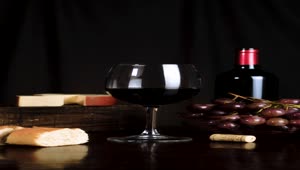 Stock Video Image Composition On A Table With Wine Cheese Grapes And Animated Wallpaper