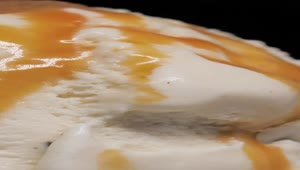 Stock Video Ice Cream With Caramel On A Black Background Animated Wallpaper