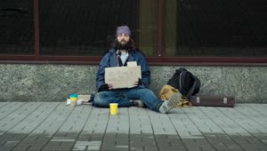 Stock Video Homeless With Cardboard Sign Sitting On The Street Animated Wallpaper