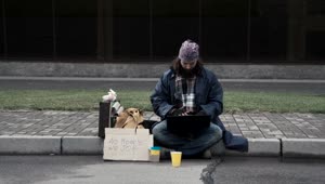 Stock Video Homeless Man With A Laptop Sitting On The Sidewalk Animated Wallpaper