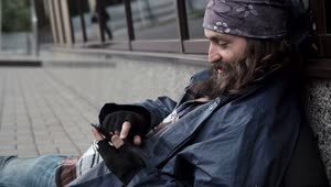 Stock Video Homeless Man Scrolling On His Phone Animated Wallpaper