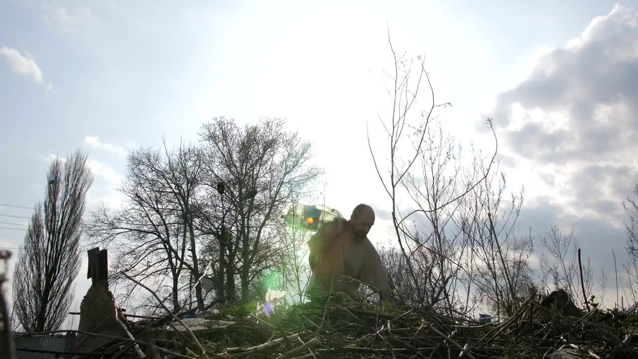 Download Stock Video Homeless Man Climbing Over Garbage Animated Wallpaper