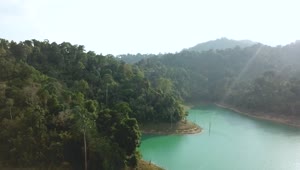 Stock Video Hills With Trees On A Turquoise Lake Animated Wallpaper