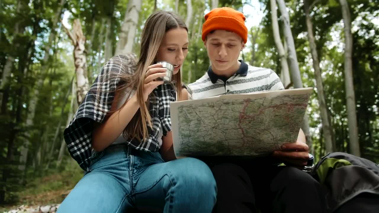 Download Stock Video Hiking Couple Resting And Looking At Map Animated Wallpaper