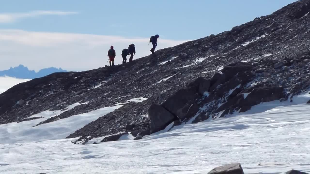 Download Stock Video Hikers On A Snowy Mountain Animated Wallpaper