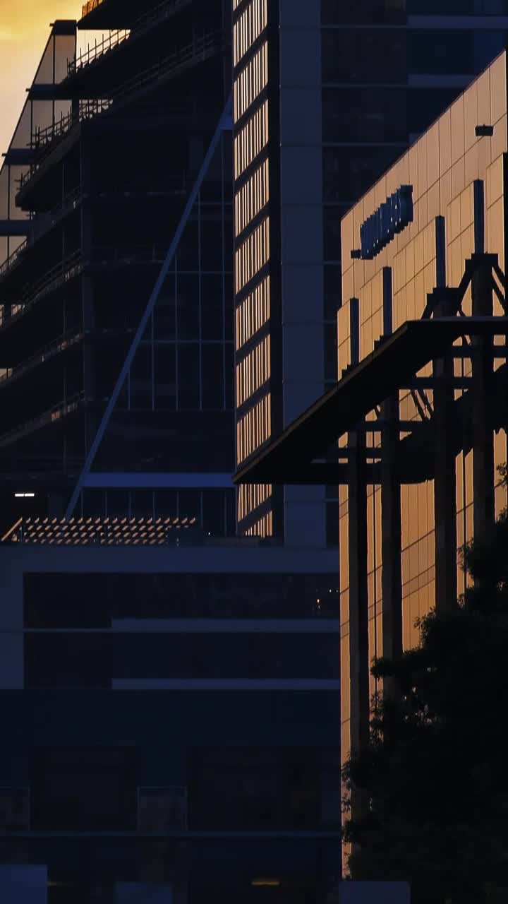 Download Stock Video High Skyscrapers Of A City During Sunset Animated Wallpaper