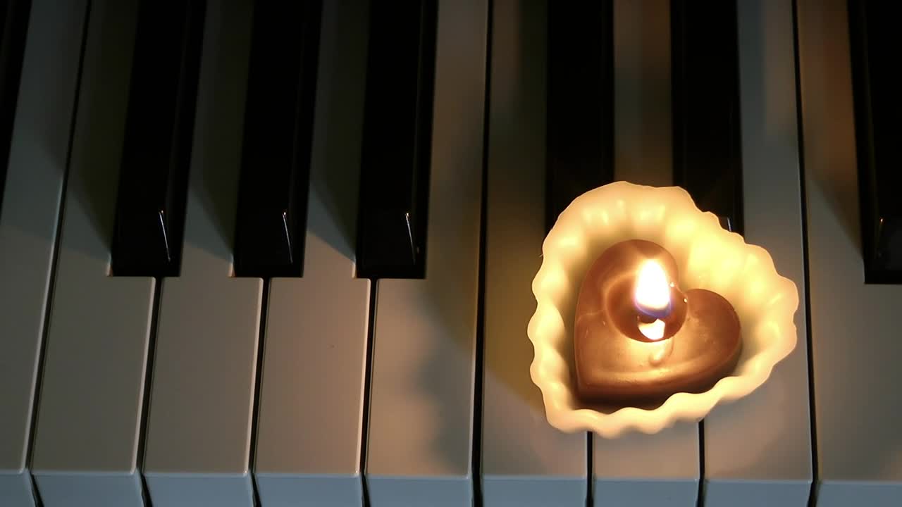Download Stock Video Heart Shaped Candle On A Piano Animated Wallpaper
