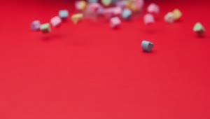 Stock Video Heart Candies Sliding On A Red Surface Animated Wallpaper