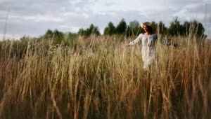 Stock Video Happy Woman In Hat Runs Through Tall Grass Animated Wallpaper
