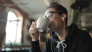 Stock Video Happy Urban Woman Sips Coffee And Listens To Music Animated Wallpaper