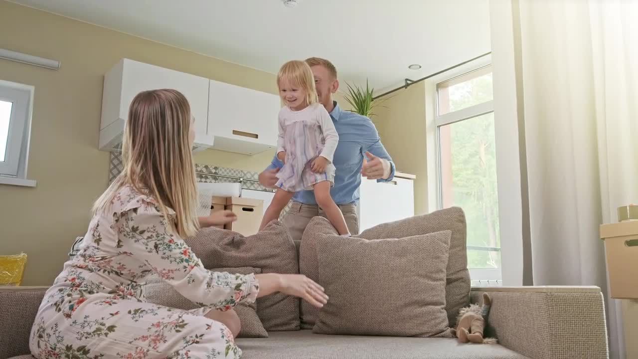 Download Stock Video Happy Parents Playing With Their Daughter Animated Wallpaper