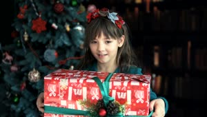 Stock Video Happy Little Girl Waving Her Christmas Gift Animated Wallpaper