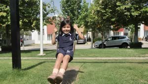 Stock Video Happy Little Girl On A Swing In A Park Animated Wallpaper