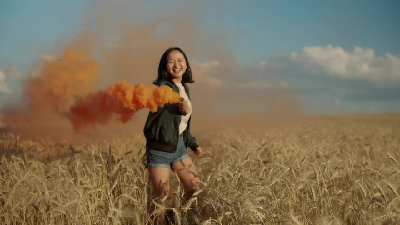Download Stock Video Happy Girl Jumping With A Smoke Flare Animated Wallpaper