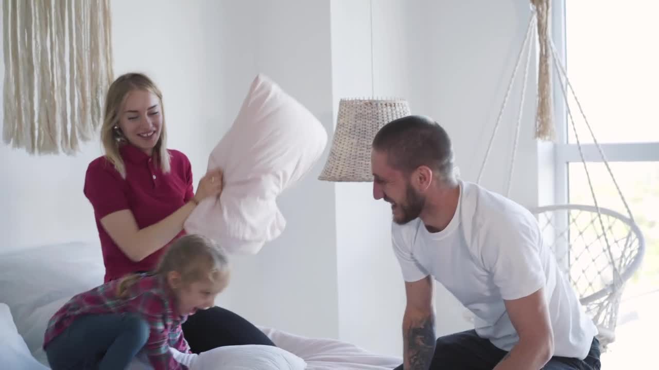 Download Stock Video Happy Family Playing With Pillows Animated Wallpaper