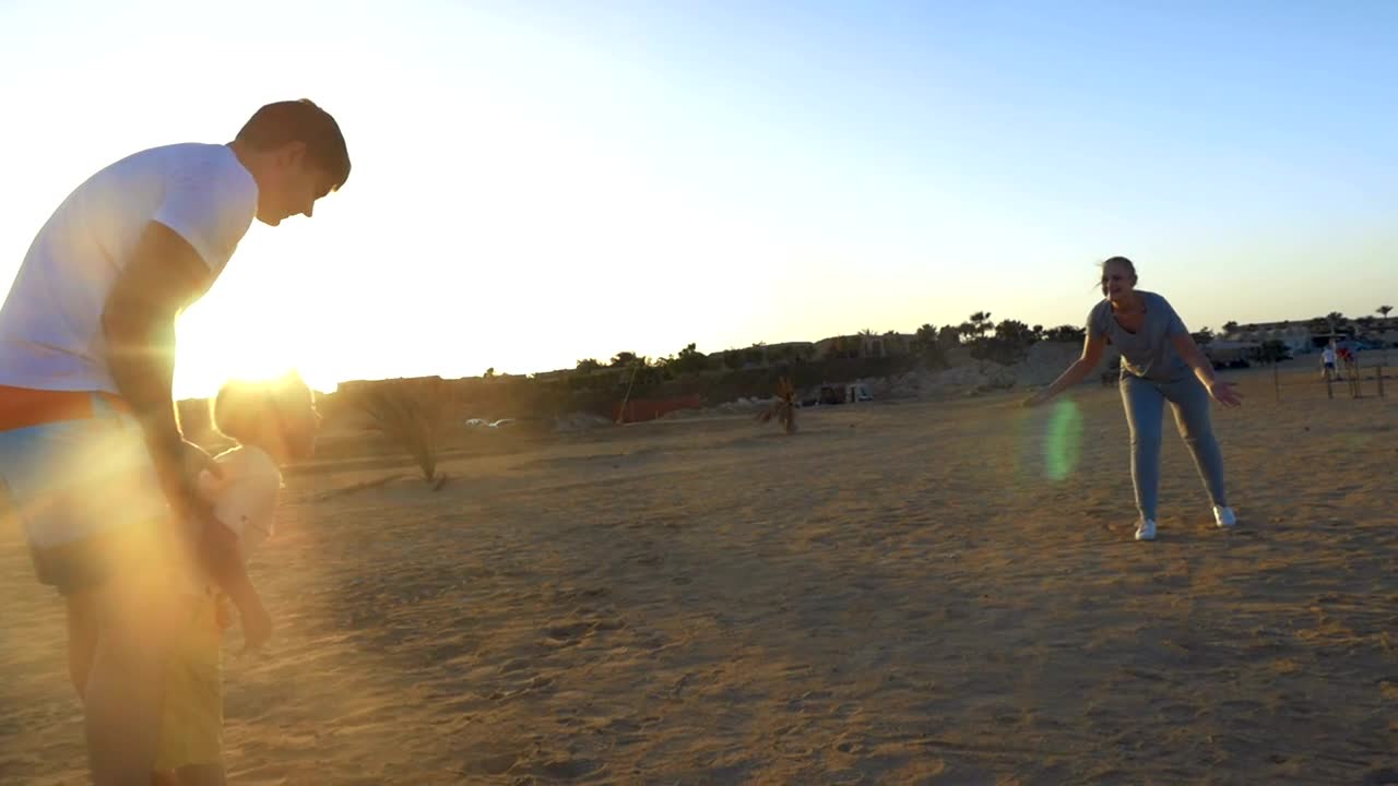 Download Stock Video Happy Family Playing In The Sand Animated Wallpaper