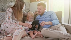 Stock Video Happy Family Laughing While Using A Tablet Animated Wallpaper