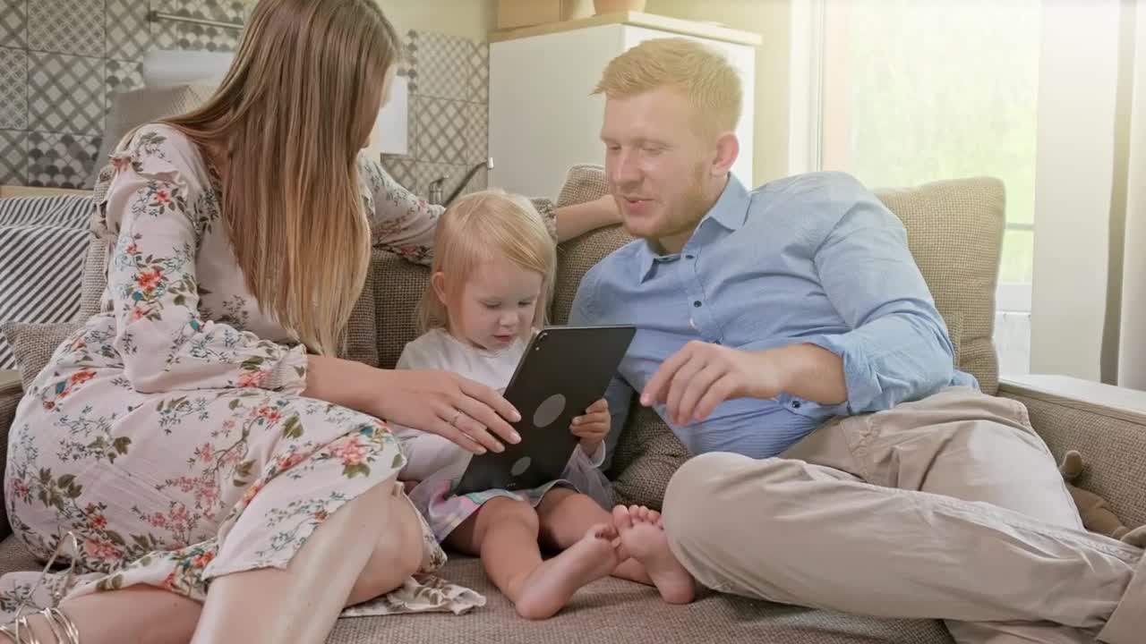 Download Stock Video Happy Family Laughing While Using A Tablet Animated Wallpaper