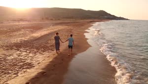 Stock Video Happy Couple Walks Along The Beach At The Seaside Animated Wallpaper