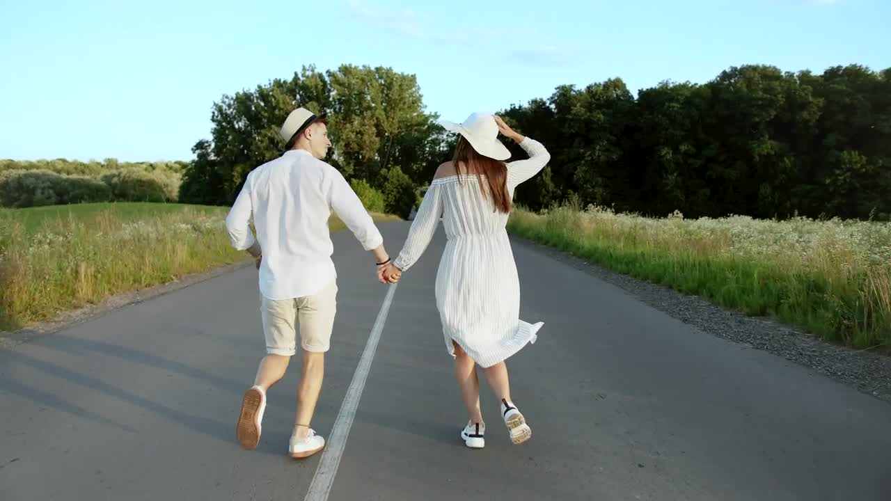 Download Stock Video Happy Couple Running Down A Road Animated Wallpaper