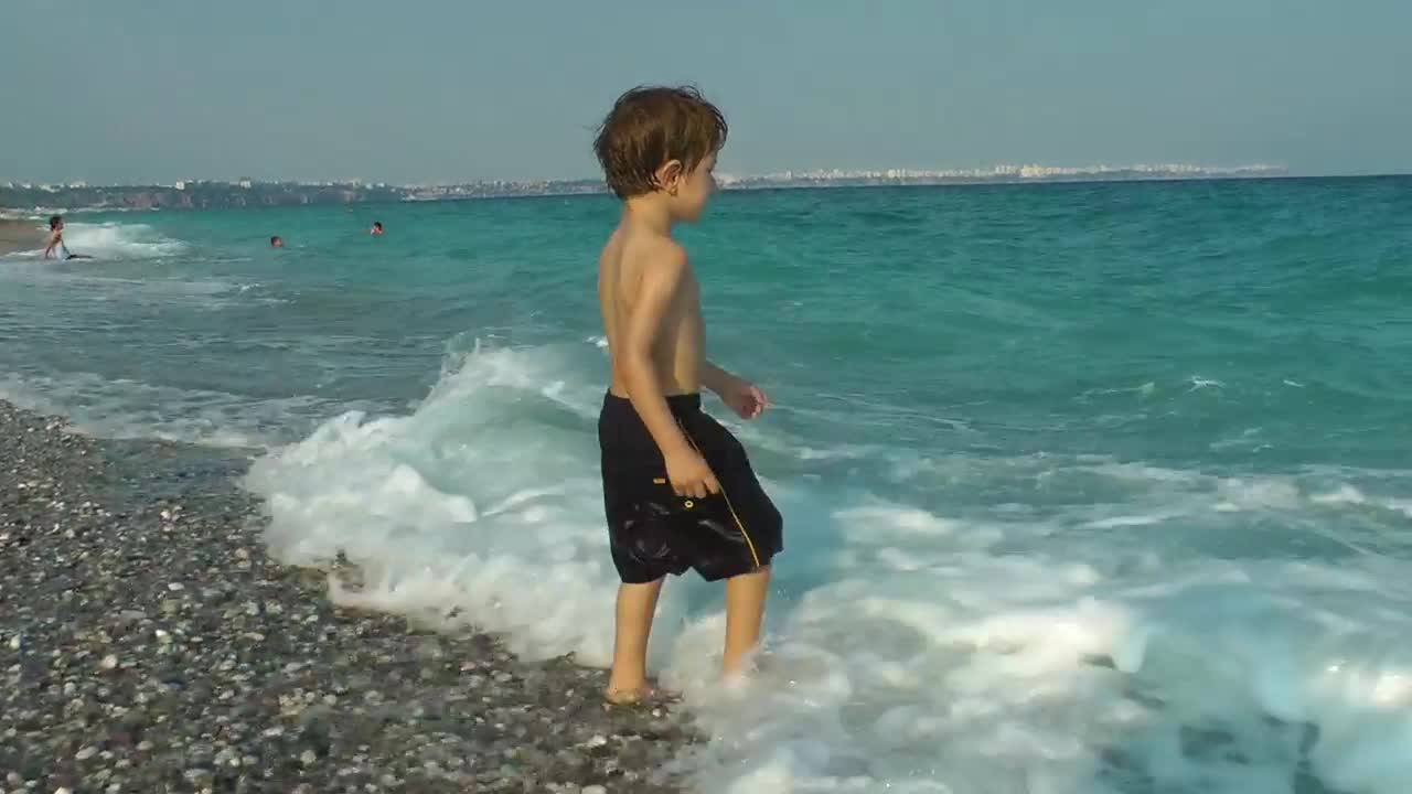 Download Stock Video Happy Child Playing With The Sea Waves Animated Wallpaper