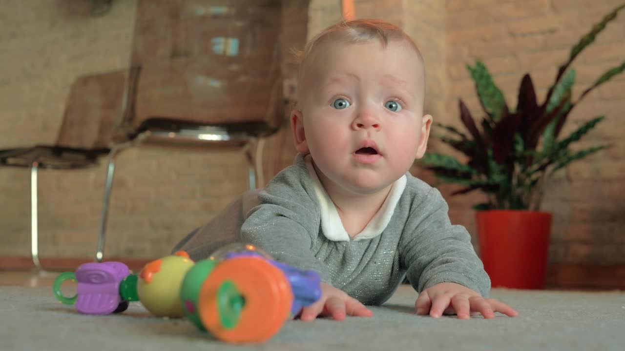 Download Stock Video Happy Baby Girl Laying On The Floor Animated Wallpaper