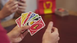 Stock Video Hands Of A Person Playing A Game Of Uno Animated Wallpaper