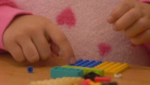 Stock Video Hands Of A Girl Playing With Lego Pieces Animated Wallpaper