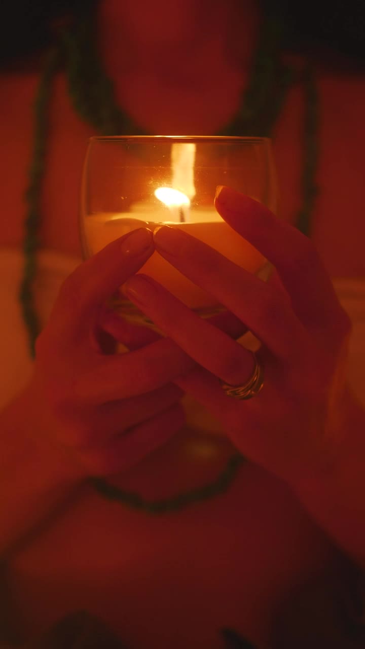 Download Stock Video Hands Of A Girl Holding A Candle In The Dark Animated Wallpaper