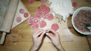 Stock Video Hands Making Red Dumplings On The Table Animated Wallpaper