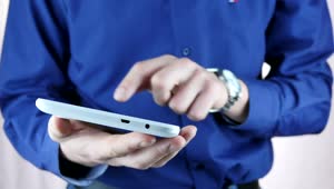 Stock Video Man In Blue Shirt Using A Tablet Animated Wallpaper