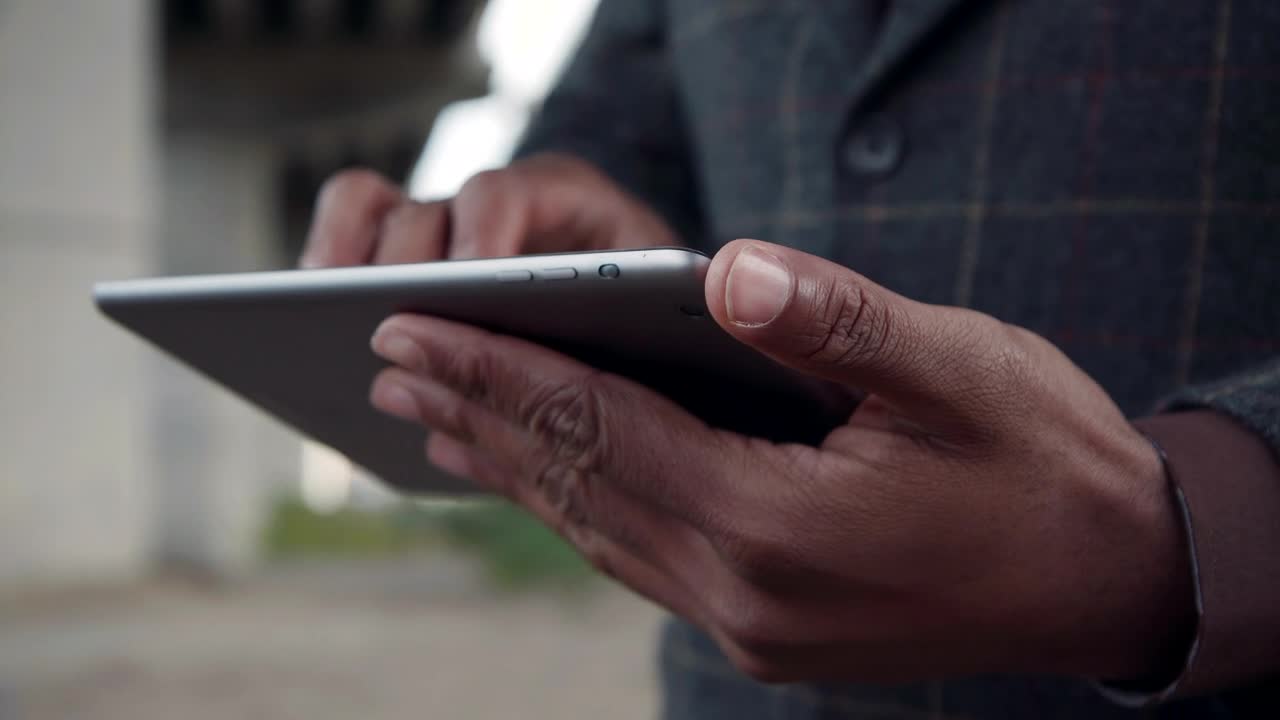 Download Stock Video Man In A Suit Using A Tablet Animated Wallpaper