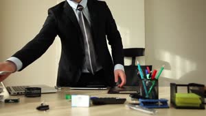 Stock Video Man In A Suit Organizing His Office Animated Wallpaper