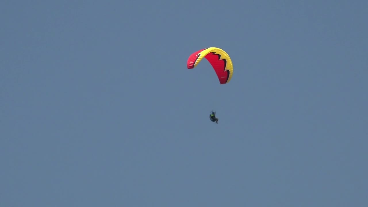 Download Stock Video Man In A Red Paraglide In The Sky Animated Wallpaper